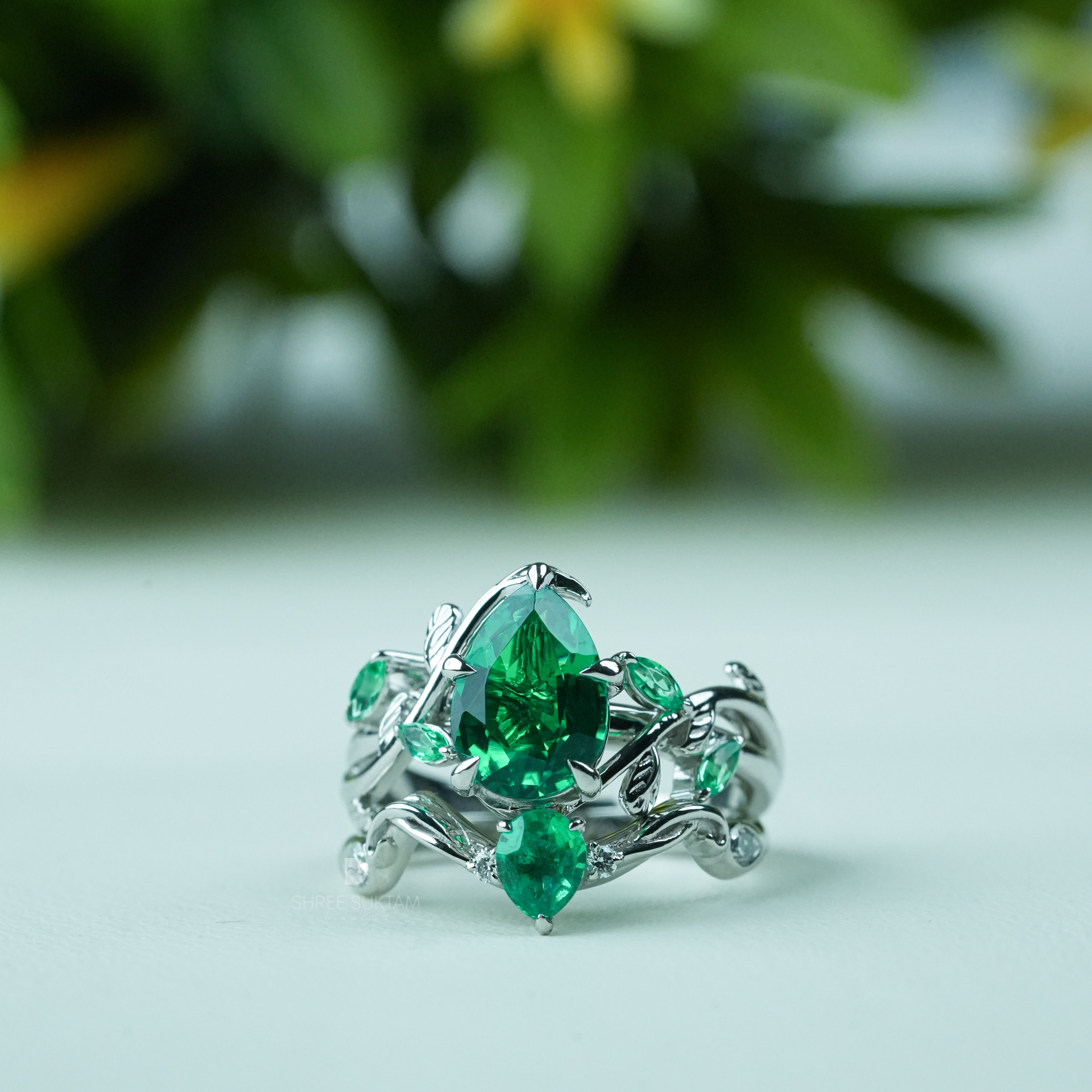 Emerald engagement ring, nature inspired ring, vine leaf ring, silver emerald jewelry, green gemstone ring, pear cut emerald ring, statement emerald ring, vintage style emerald ring, botanical jewelry, leaf design ring, gemstone promise ring, emerald wedding ring, nature lover jewelry, unique emerald ring, silver gemstone ring, anniversary gift ring, handmade emerald jewelry, bridal emerald ring, boho emerald ring, luxury gemstone jewelry.